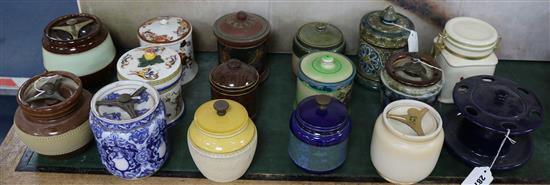 A Royal Doulton tube-lined tobacco jar, fifteen other tobacco jars, various and a pottery pipe rack (17)